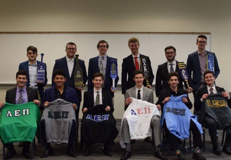 Alpha Epsilon Pi brothers with their painted paddles and letters
